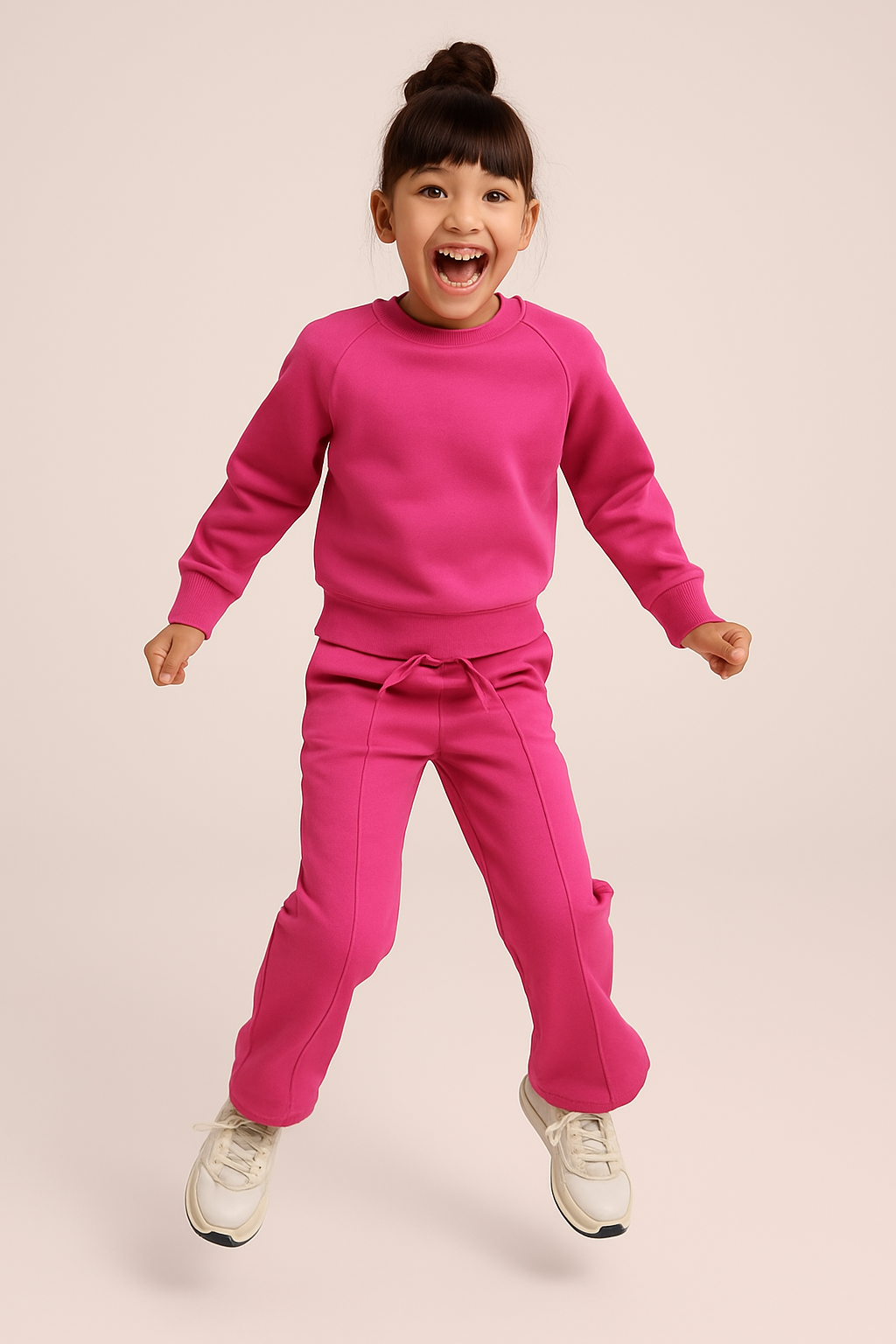 Girl Jumping in Pink Sweatshirt and Jogger Pant Set